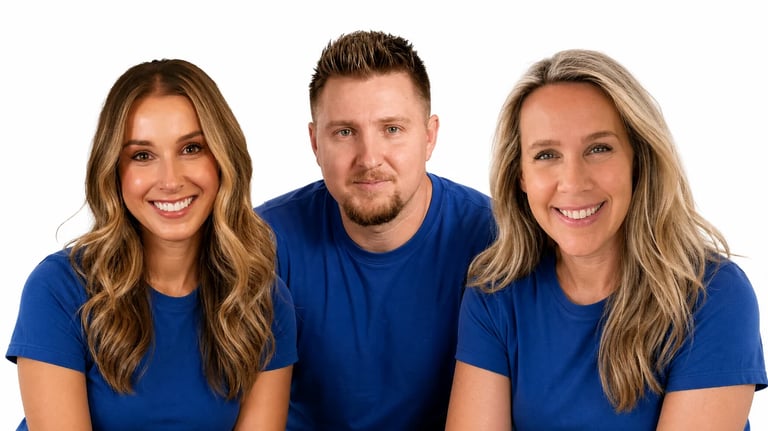 Three smiling people wearing blue t-shirts posing together for a professional headshot against a white background